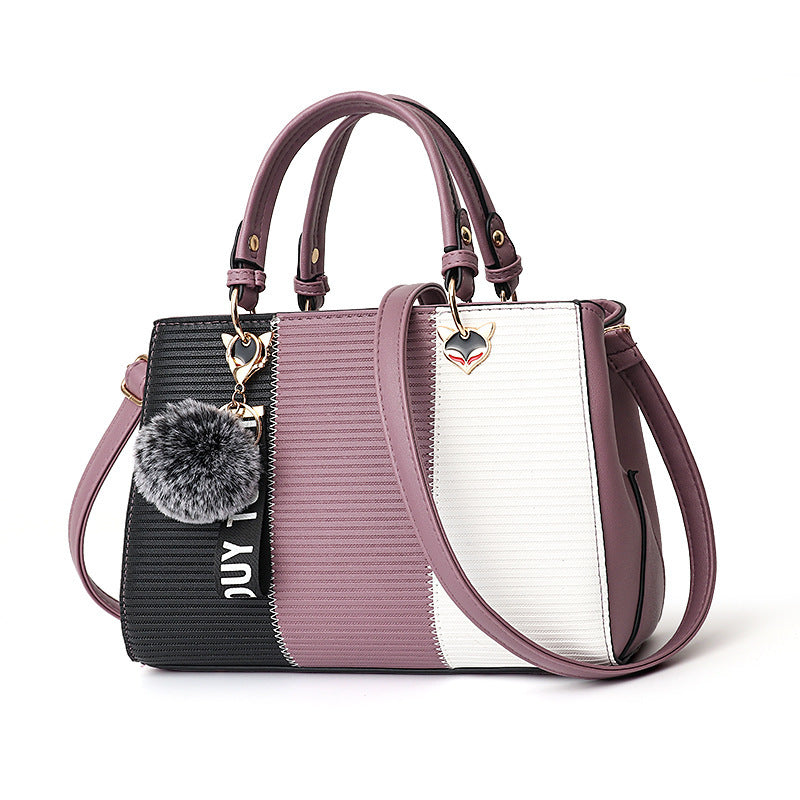 Stylish MONO//FIT women's crossbody shoulder bag with a chic design and detachable pom-pom charm