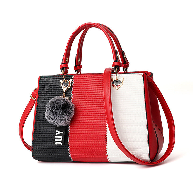 Stylish MONO//FIT women's crossbody shoulder bag with red and black stripes and a fur pom-pom charm