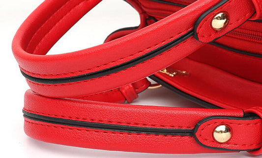 Close-up of a red MONO//FIT women's crossbody shoulder bag showcasing the stylish handles and quality stitching